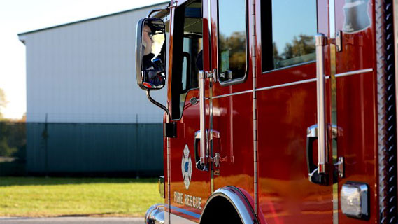 A firefighter driving a firetruck