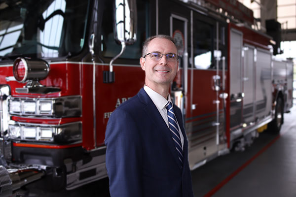 Peter Feid standing in front of a firetruck