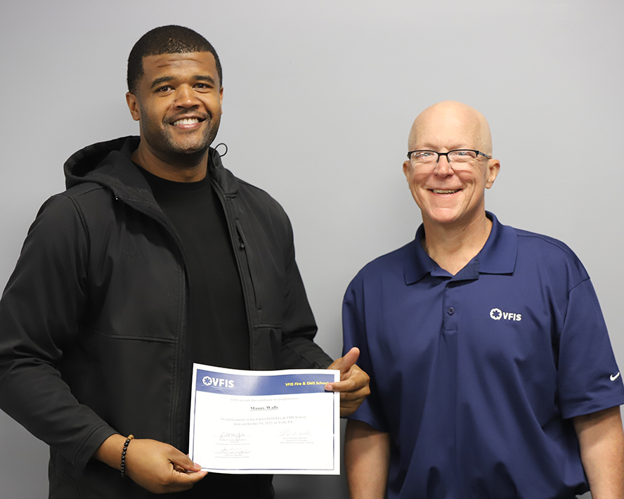 David handing a certificate to Manny