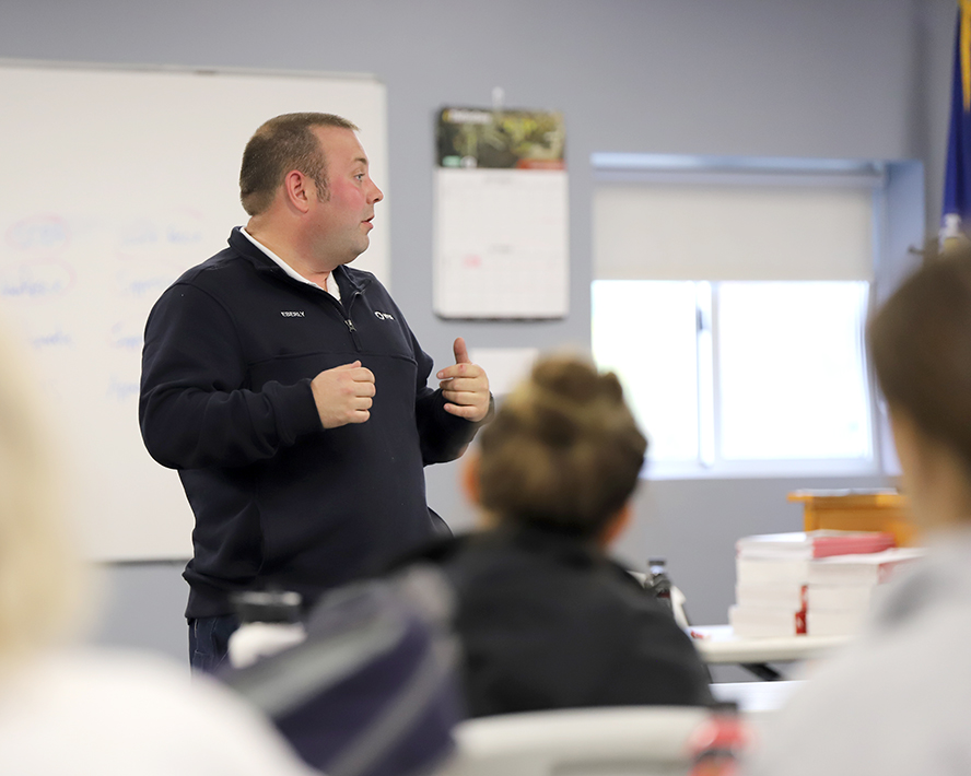 Justin standing in front of a classroom